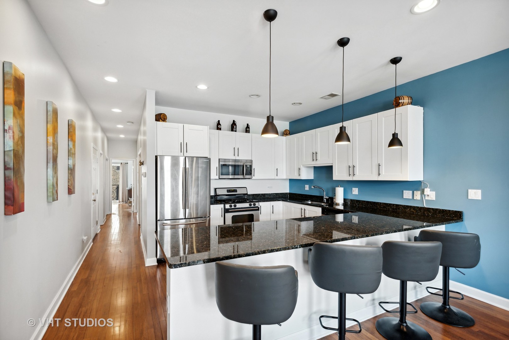 523 North Racine Avenue, Unit 4 Chicago, IL 60642 - Photo 5 of 17 a kitchen with stainless steel appliances granite countertop a sink a stove and a refrigerator
