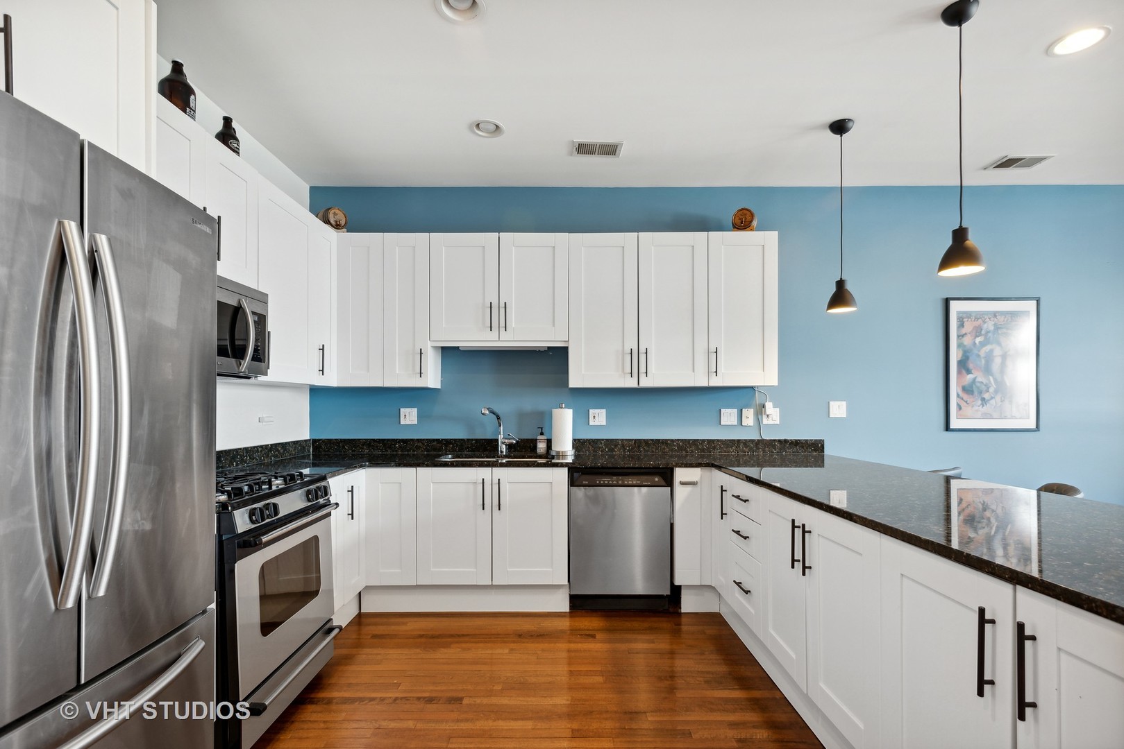 523 North Racine Avenue, Unit 4 Chicago, IL 60642 - Photo 8 of 17 a kitchen with cabinets stainless steel appliances a sink and wooden floor