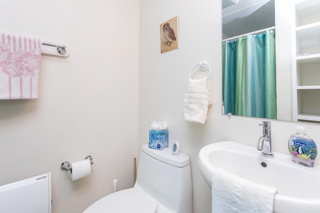 28 Andover Street Peabody, MA 01960 - Photo 15 of 30 a bathroom with a sink a toilet and a mirror