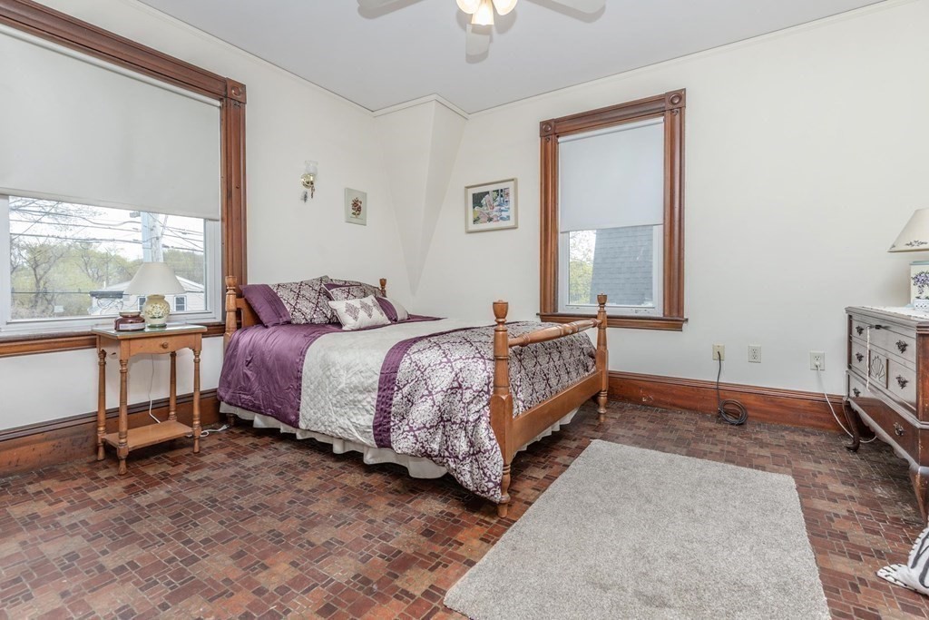 28 Andover Street Peabody, MA 01960 - Photo 16 of 30 a bedroom with a bed lamp and a large window