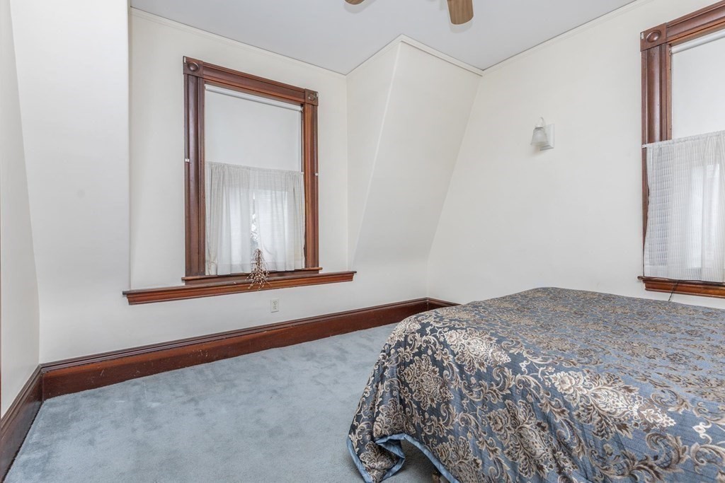28 Andover Street Peabody, MA 01960 - Photo 21 of 30 a bedroom with a bed and a window