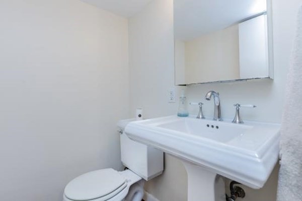 28 Andover Street Peabody, MA 01960 - Photo 26 of 30 a bathroom with a sink a toilet and mirror