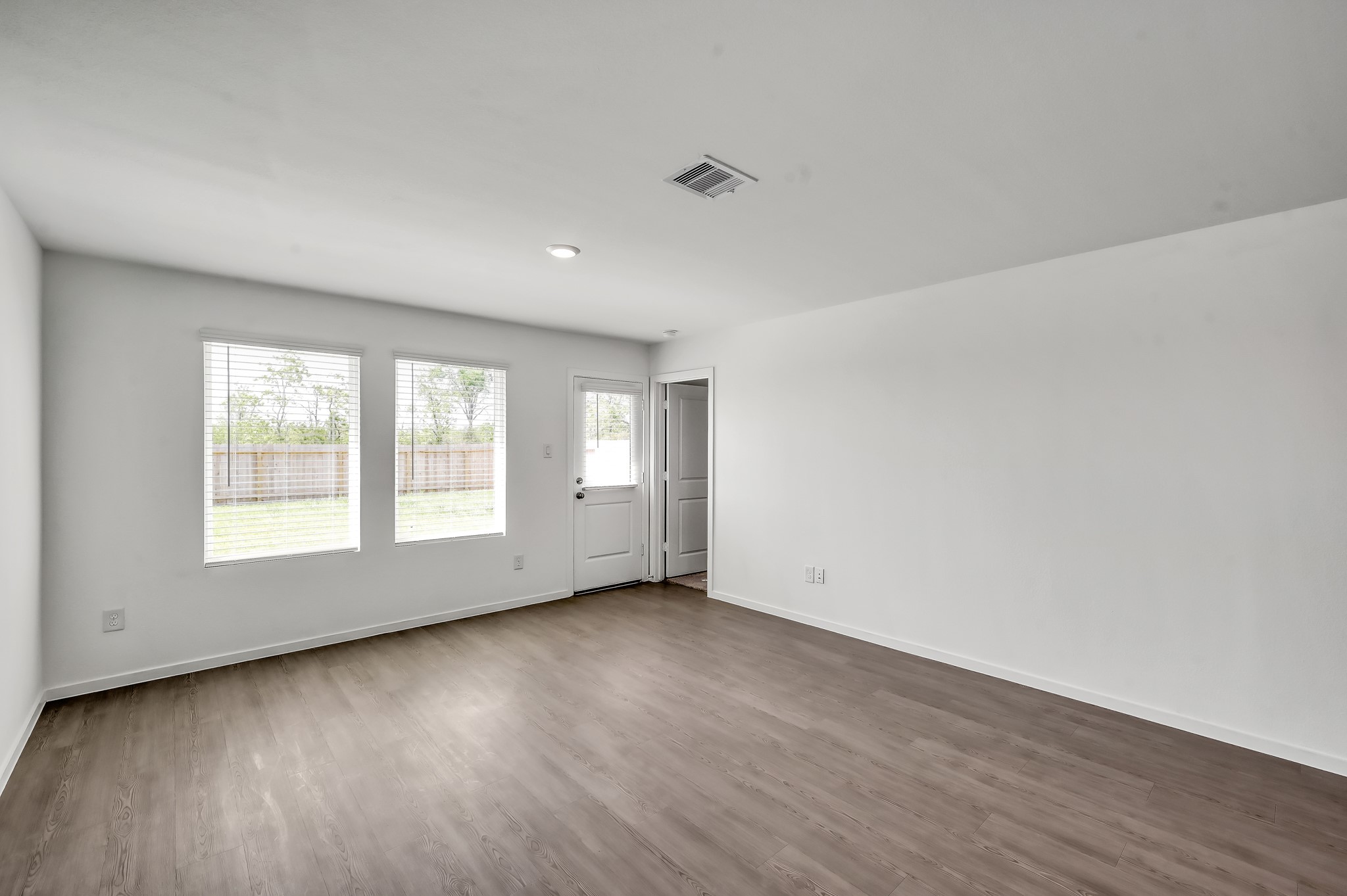 29635 Knollwood Bay Road Waller, TX 77484 - Photo 11 of 39 an empty room with wooden floor and windows