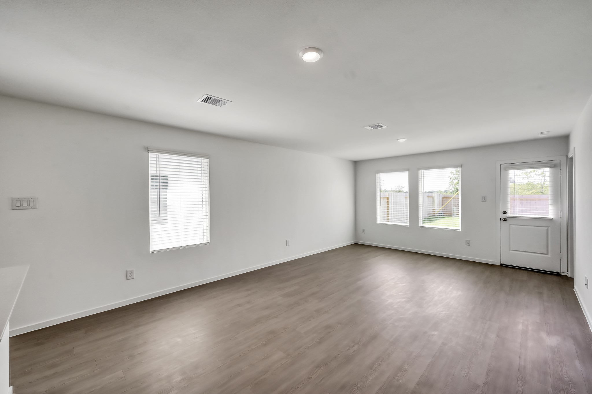 29635 Knollwood Bay Road Waller, TX 77484 - Photo 14 of 39 an empty room with wooden floor and windows