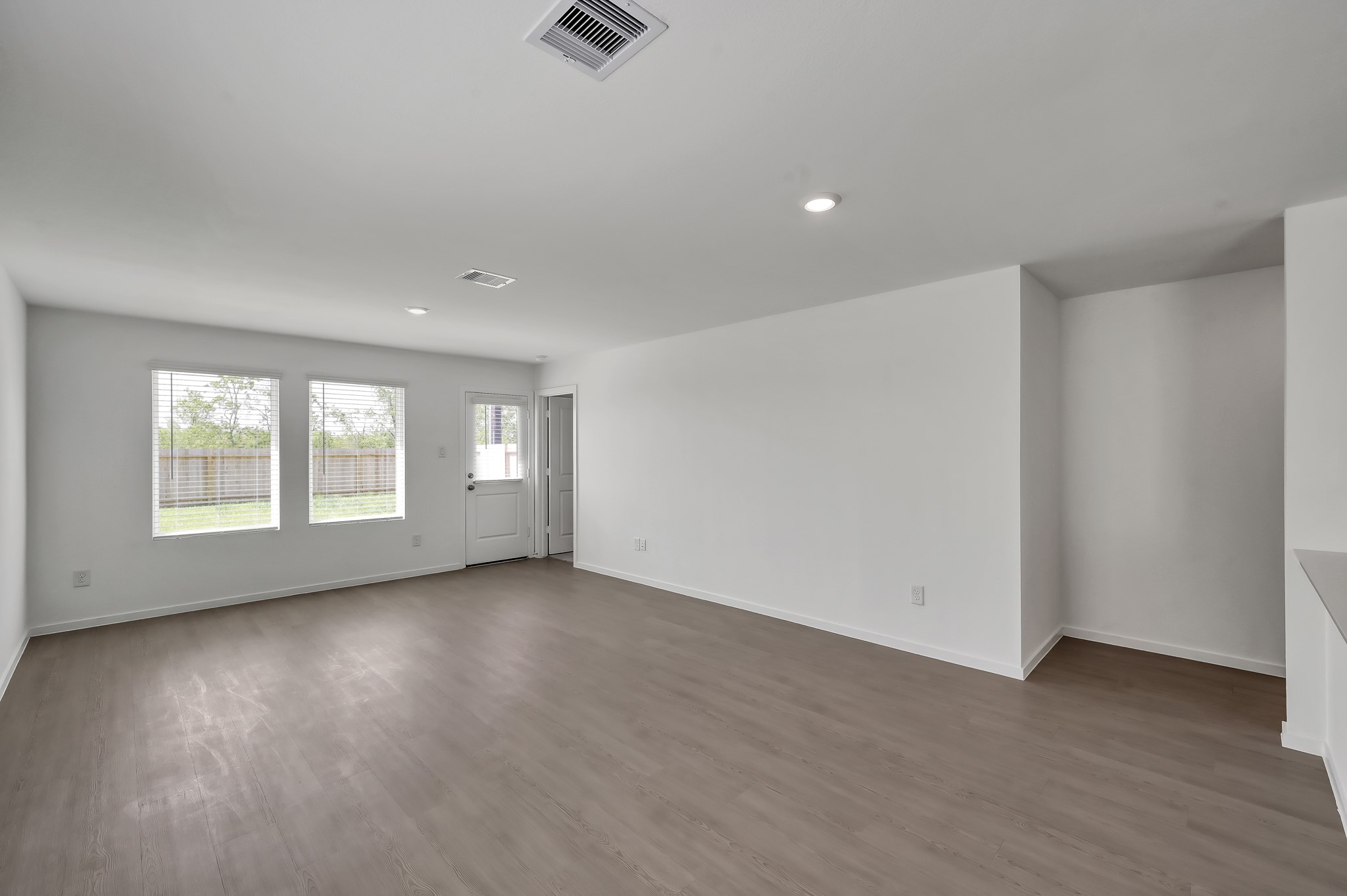 29635 Knollwood Bay Road Waller, TX 77484 - Photo 15 of 39 wooden floor in an empty room with a window