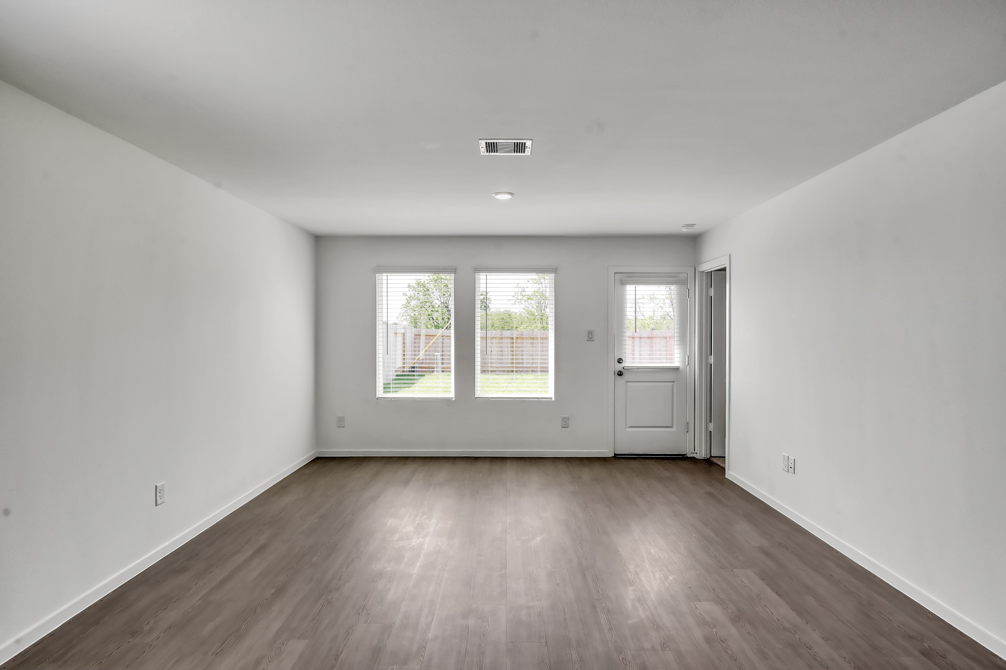 29635 Knollwood Bay Road Waller, TX 77484 - Photo 10 of 39 an empty room with wooden floor and windows