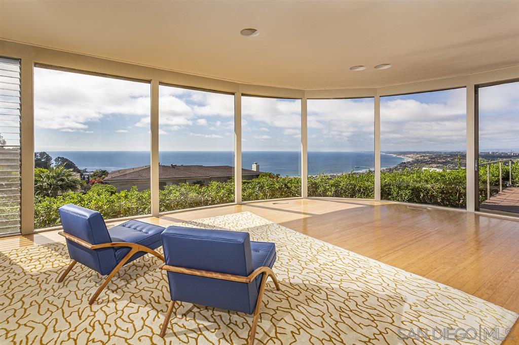 7245 Rue De Roark La Jolla, CA 92037 - Photo 1 of 21 a living room with a large window and a table