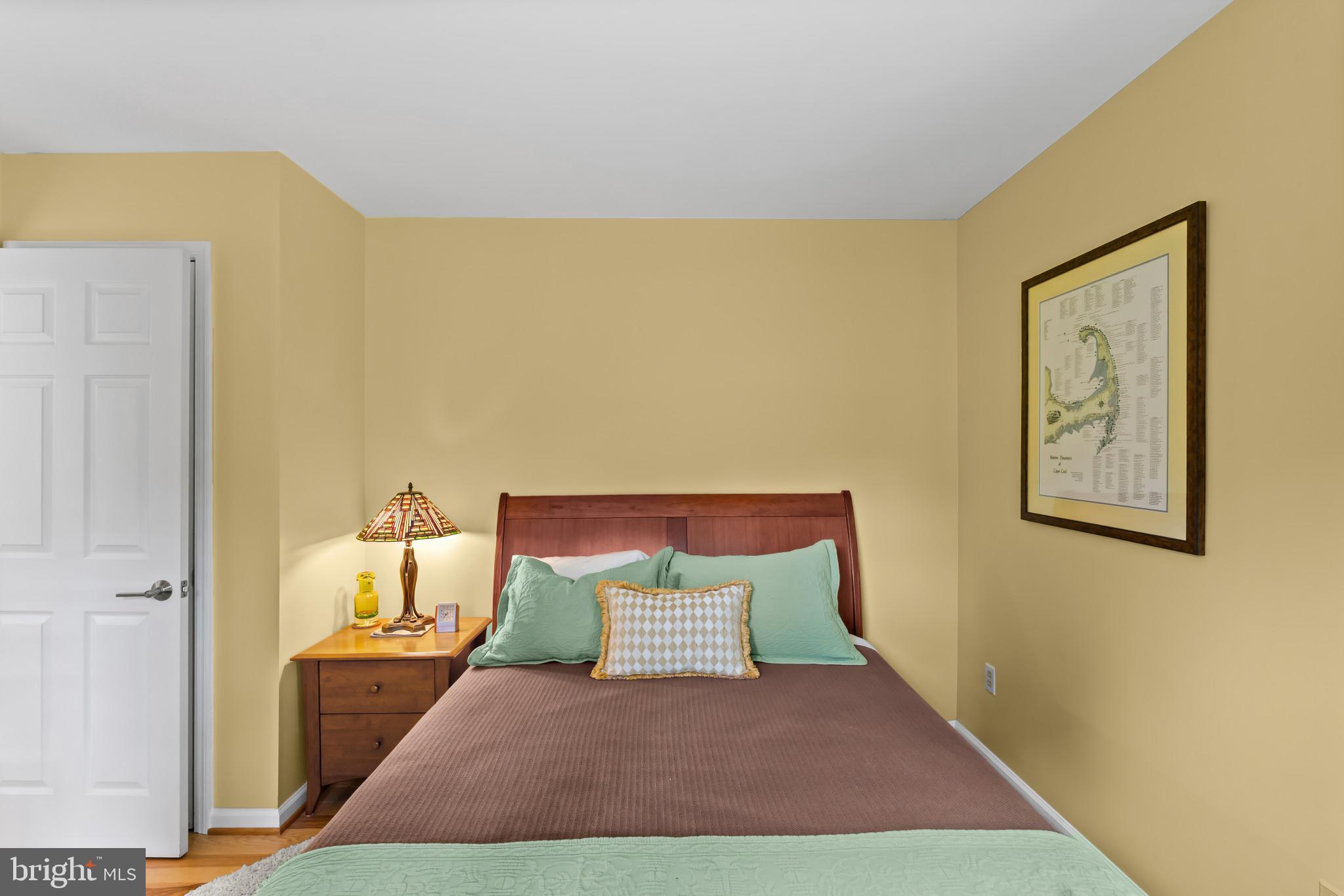 10821 Braeburn Road Columbia, MD 21044 - Photo 19 of 64 a view of a bedroom with a bed and wooden floor