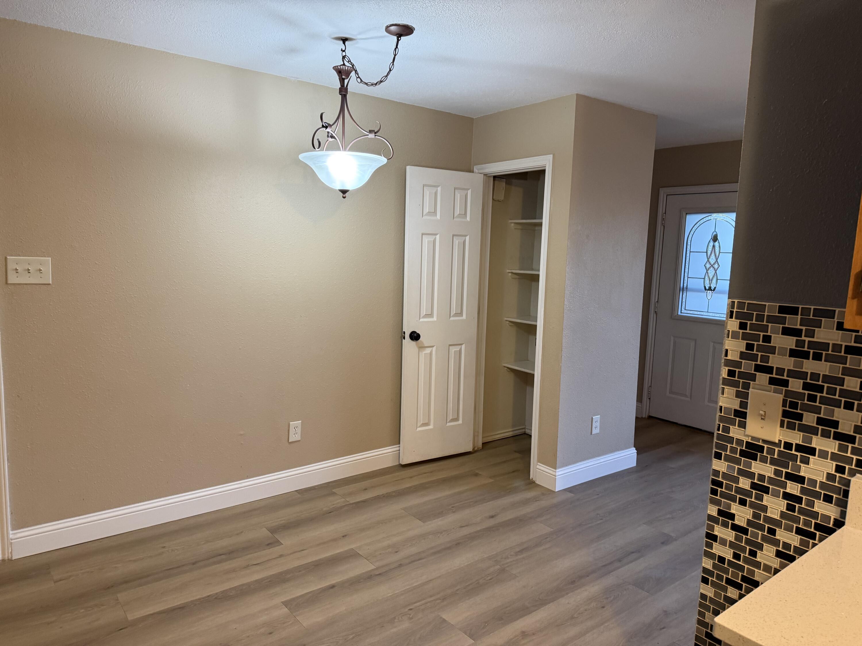 2523 110th Street Lubbock, TX 79423 - Photo 12 of 23 wooden floor in an empty room with a window