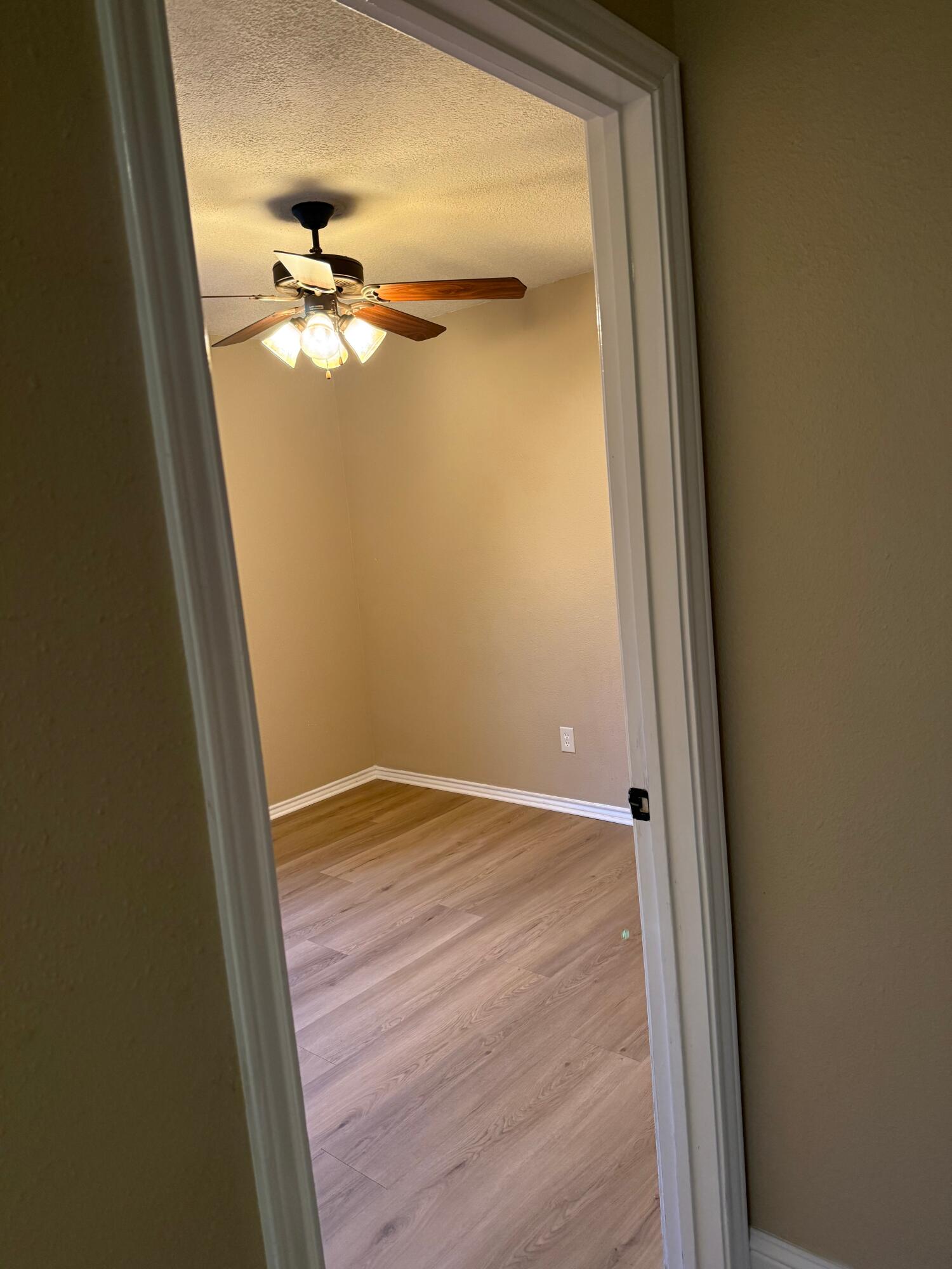 2523 110th Street Lubbock, TX 79423 - Photo 17 of 23 a view of empty room with wooden floor