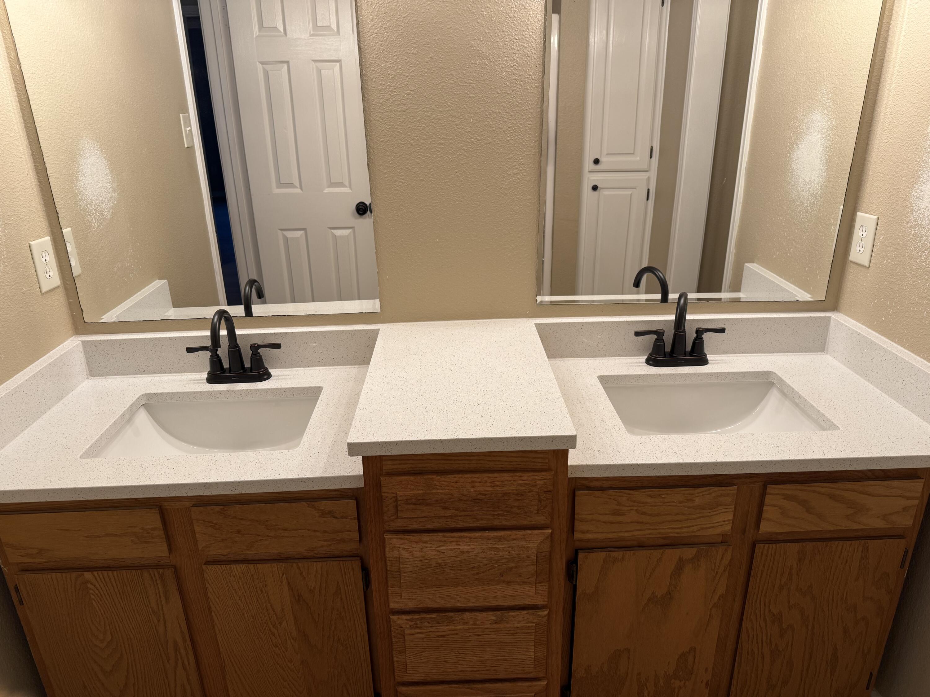 2523 110th Street Lubbock, TX 79423 - Photo 20 of 23 a bathroom with a sink and a mirror