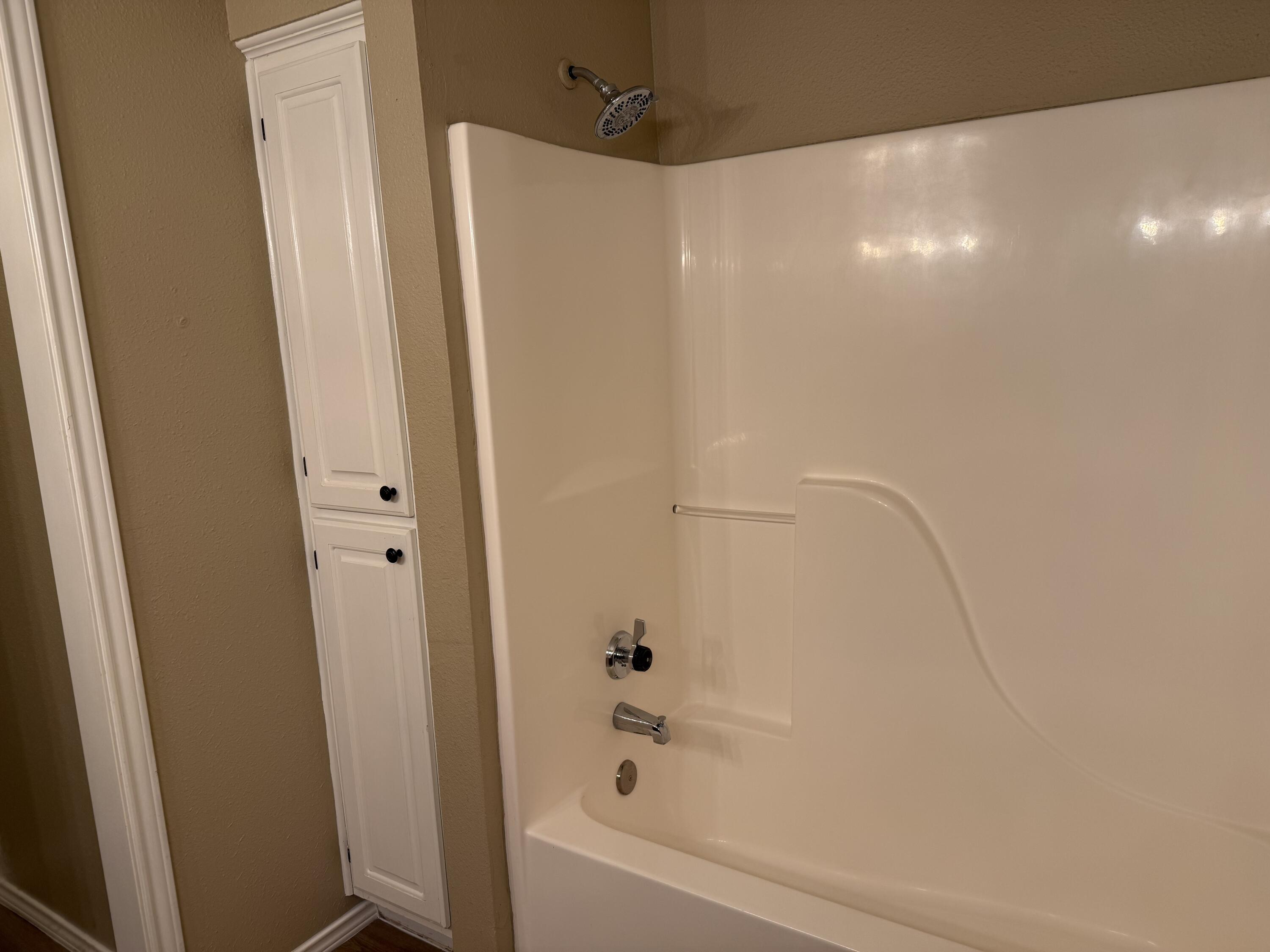 2523 110th Street Lubbock, TX 79423 - Photo 22 of 23 a bathroom with a bathtub