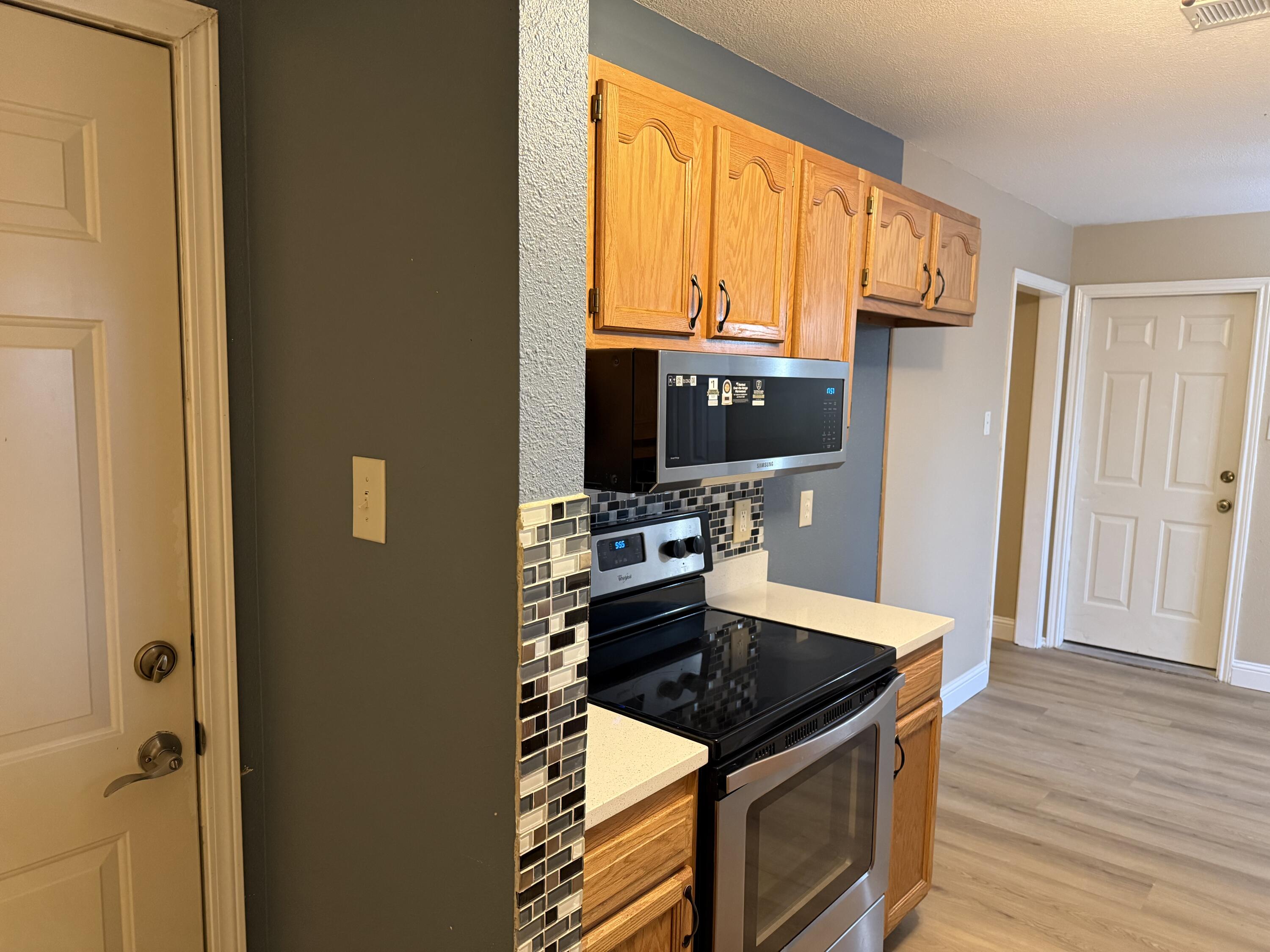2523 110th Street Lubbock, TX 79423 - Photo 9 of 23 a kitchen with a stove a sink and a refrigerator