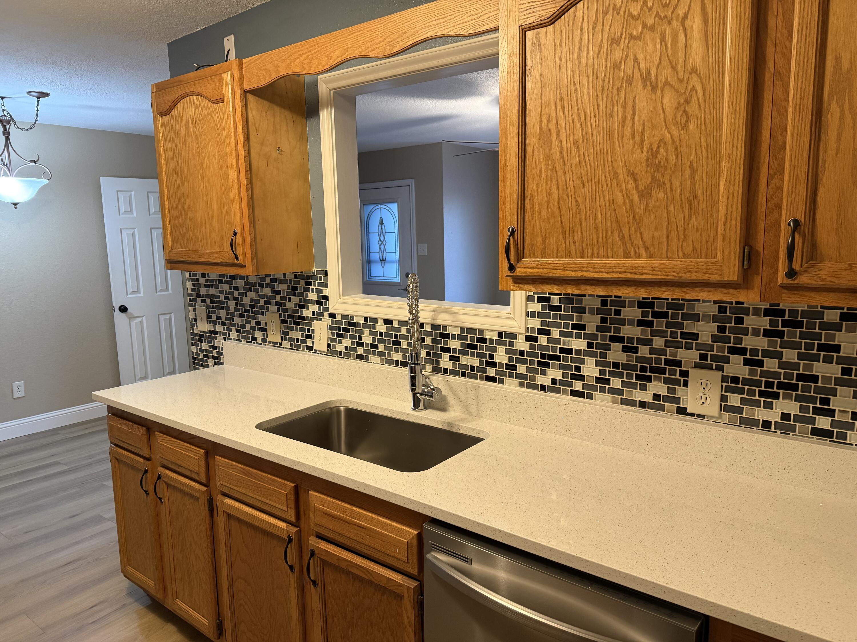 2523 110th Street Lubbock, TX 79423 - Photo 10 of 23 a kitchen with a sink and cabinets