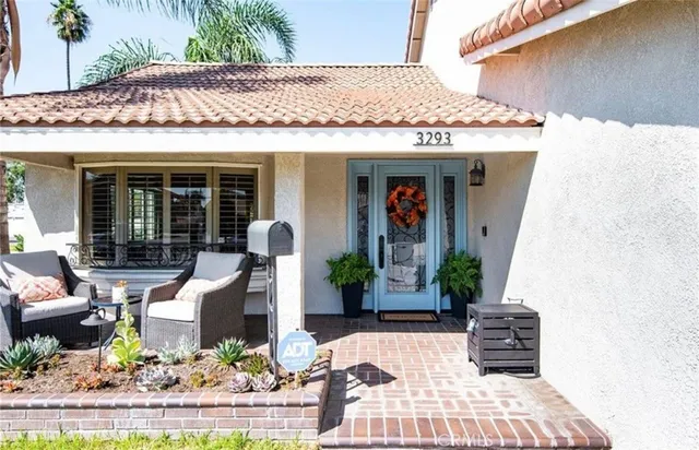 a view of a patio with table and chairs potted plants
