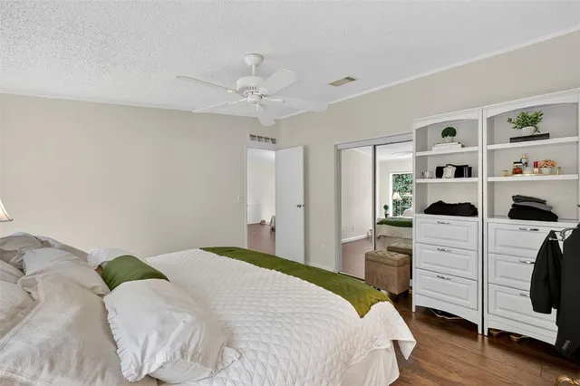 a bedroom with a bed and a white cabinets