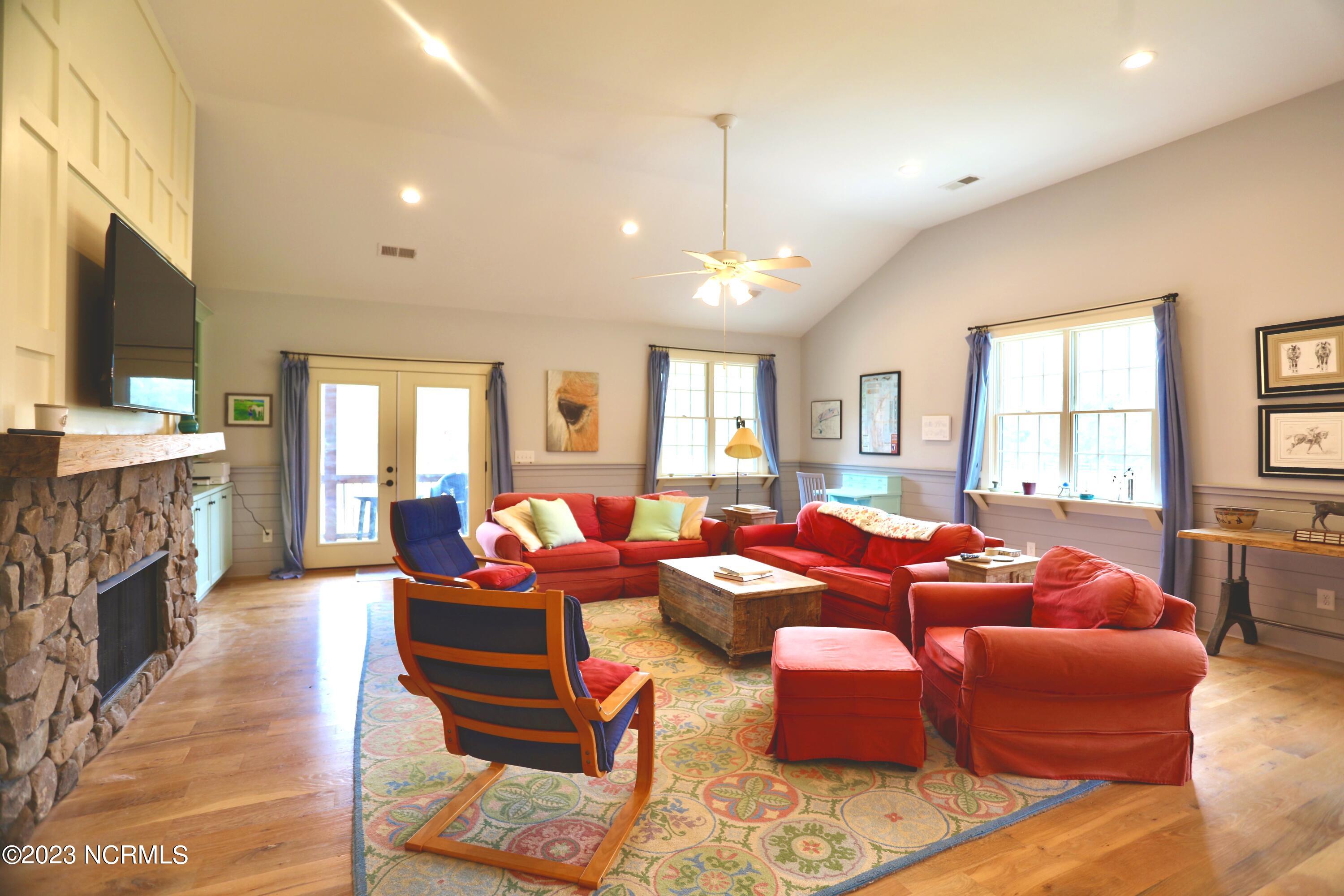 2545 Lakebay Road Vass, NC 28394 - Photo 36 of 58 The great room offer plenty of couch space and leads to the screened in porch.