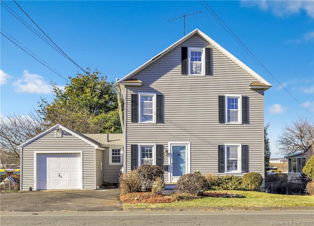 1004 Stratford Road Stratford, CT 06615 - Photo 1 of 1 a front view of a house with a yard and garage
