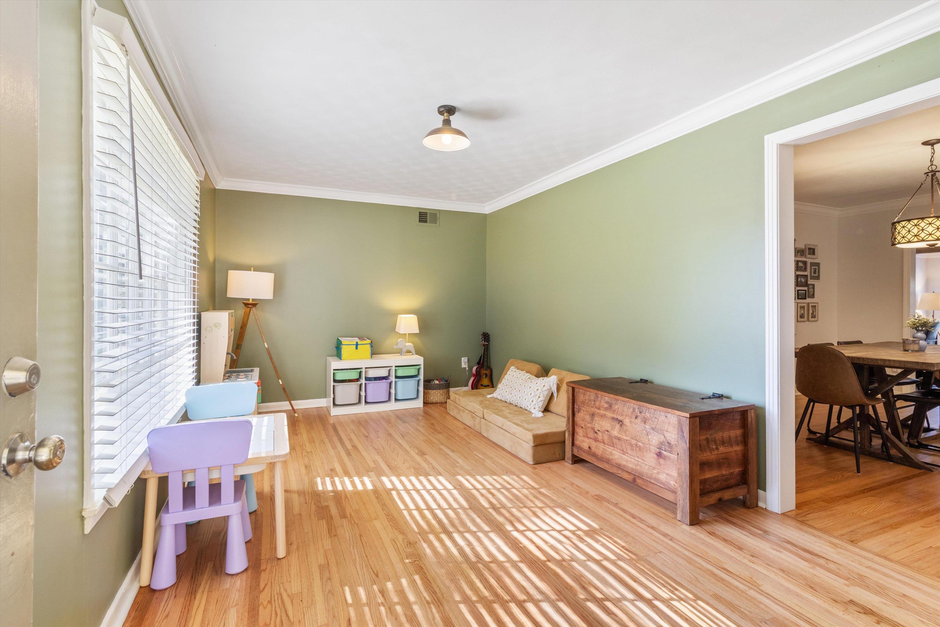 5022 Sea Isle Road Memphis, TN 38117 - Photo 4 of 28 a bedroom with a bed and wooden floor