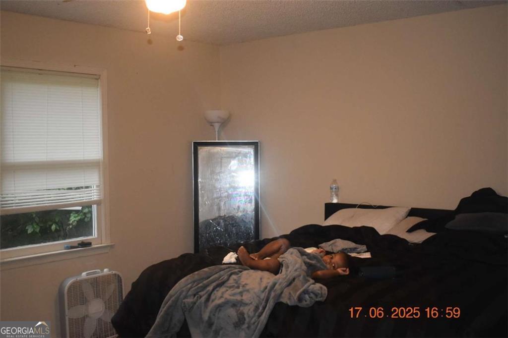 4433 Azalea Drive Macon, GA 31210 - Photo 11 of 24 a bedroom with a bed window and mirror