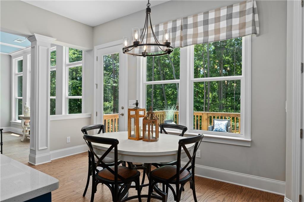 3710 Reserve Overlook Way Cumming, GA 30041 - Photo 33 of 98 a view of a dining room with furniture large windows and wooden floor