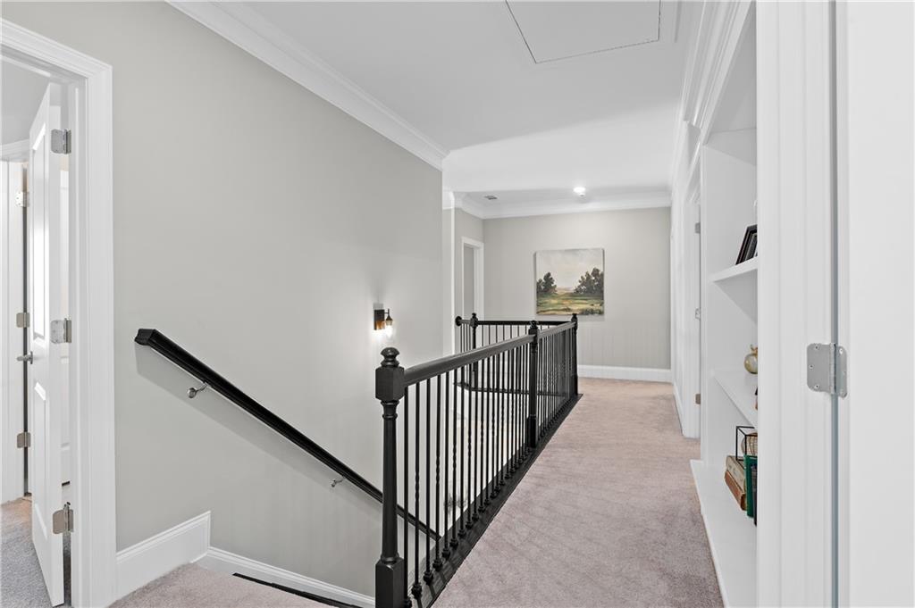 3710 Reserve Overlook Way Cumming, GA 30041 - Photo 35 of 98 a view of a hallway with wooden floor and stairs