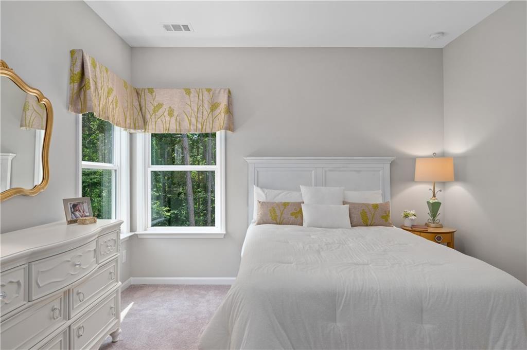 3710 Reserve Overlook Way Cumming, GA 30041 - Photo 42 of 98 a bedroom with a large bed and a large window