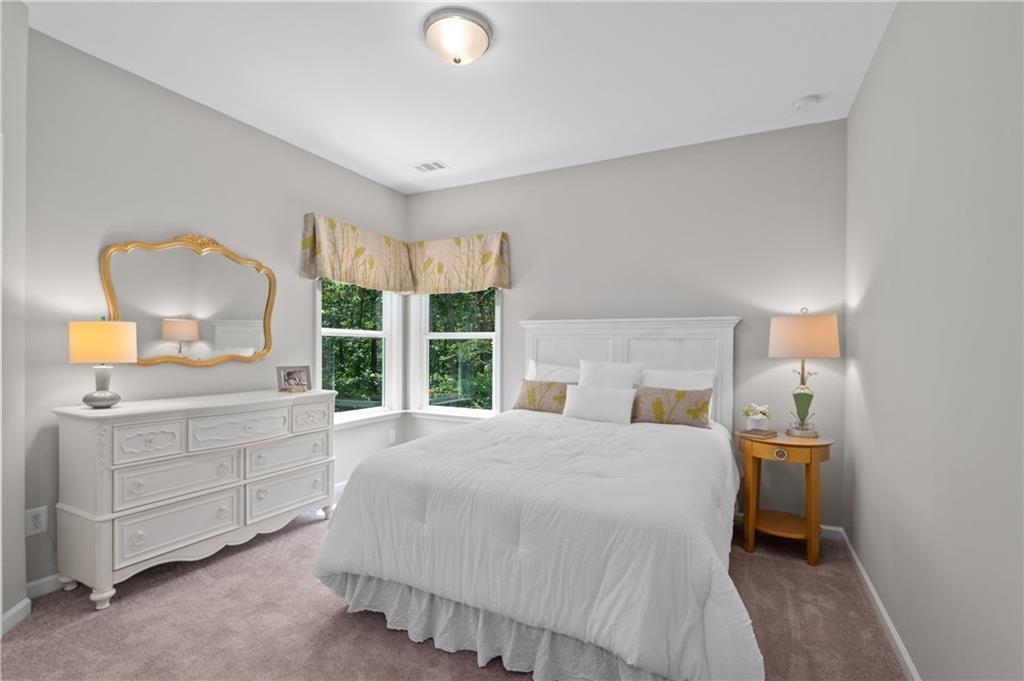 3710 Reserve Overlook Way Cumming, GA 30041 - Photo 44 of 98 a bedroom with a bed and a large window