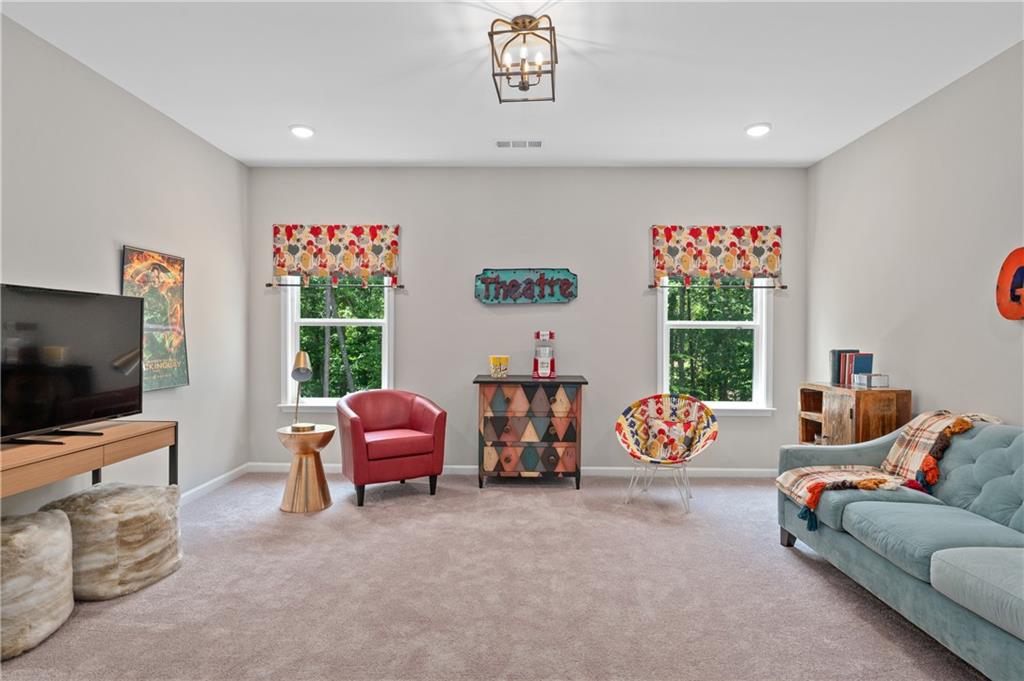 3710 Reserve Overlook Way Cumming, GA 30041 - Photo 45 of 98 a living room with furniture and a flat screen tv