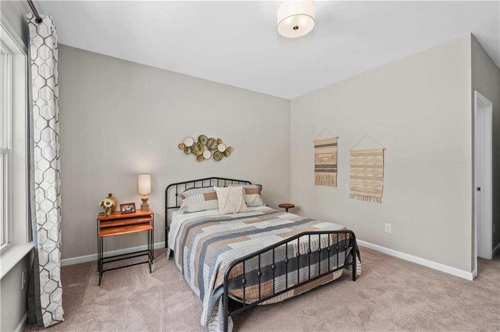 3710 Reserve Overlook Way Cumming, GA 30041 - Photo 49 of 98 a bedroom with a bed and a couch