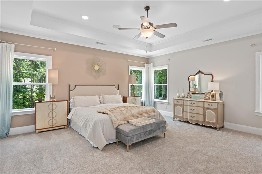 3710 Reserve Overlook Way Cumming, GA 30041 - Photo 51 of 98 a bedroom with a large bed and ceiling fan