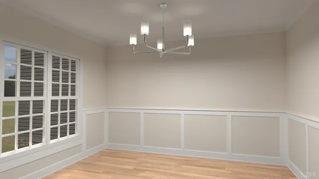 a view of empty room with wooden floor and windows