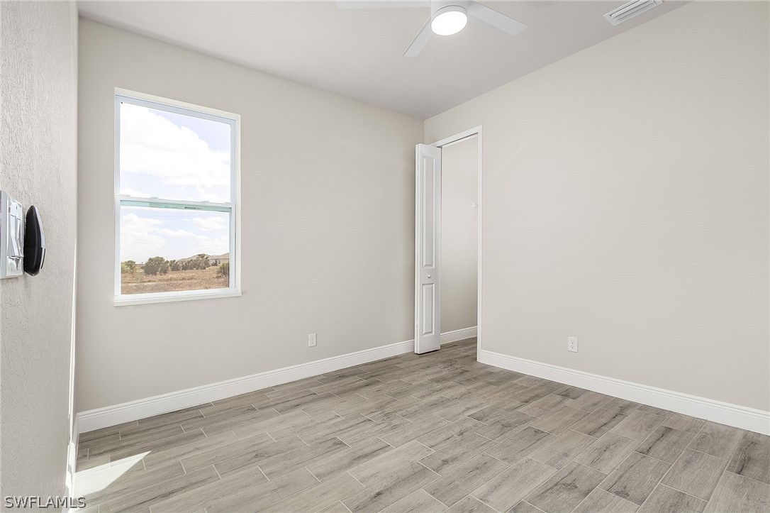 8005 Olive Circle LaBelle, FL 33935 - Photo 19 of 21 an empty room with wooden floor and windows