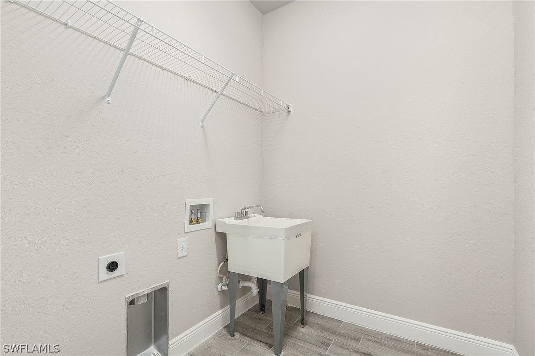 8005 Olive Circle LaBelle, FL 33935 - Photo 21 of 21 a bathroom with a sink a light fixture and a toilet