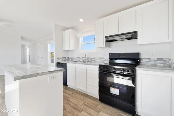 a kitchen with stainless steel appliances granite countertop a stove and a sink