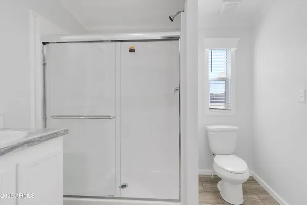 a white toilet sitting next to a bathroom sink