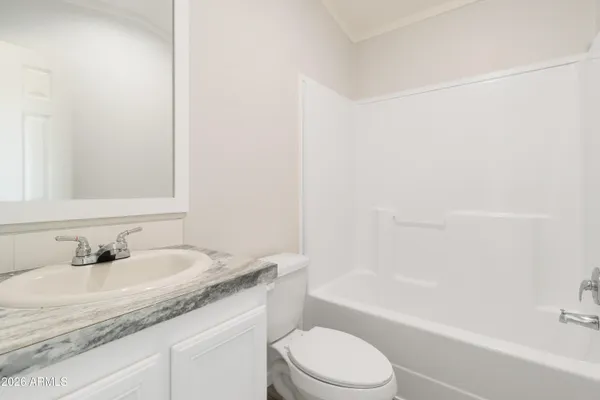 a bathroom with a granite countertop sink a toilet and bathtub
