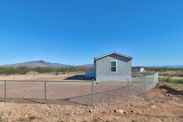 a view of a house with a backyard