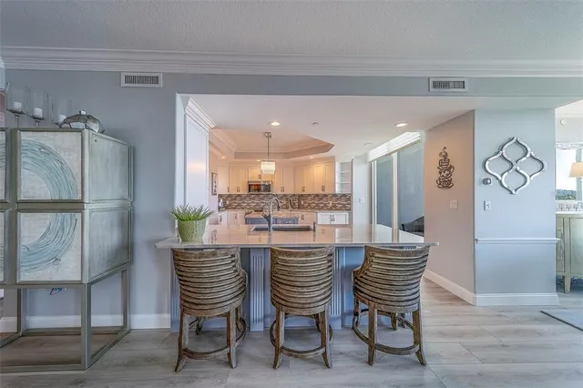 a kitchen with stainless steel appliances granite countertop a sink stove and cabinets