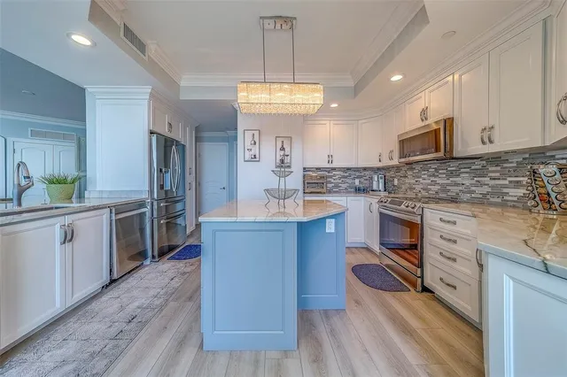 a kitchen with stainless steel appliances granite countertop a sink and cabinets