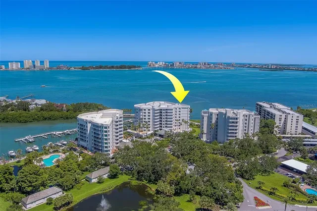 a kitchen with a table chairs refrigerator and cabinets