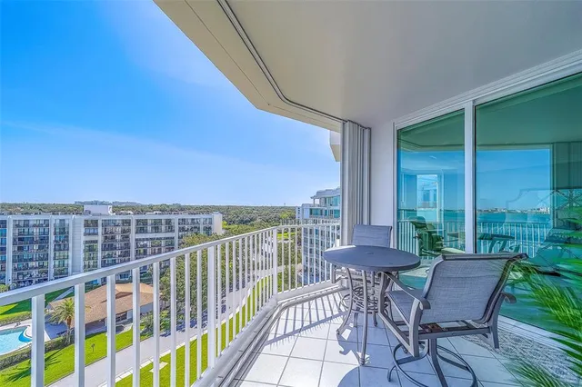 a bathroom with a granite countertop sink a mirror a toilet and shower