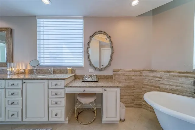 a view of a patio with table and chairs a barbeque with wooden floor and fence