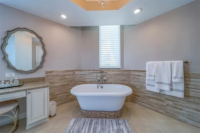 a view of swimming pool with outdoor seating and lake view