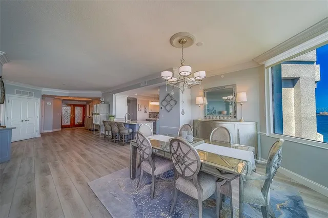 a kitchen with stainless steel appliances kitchen island granite countertop a stove a sink and a refrigerator