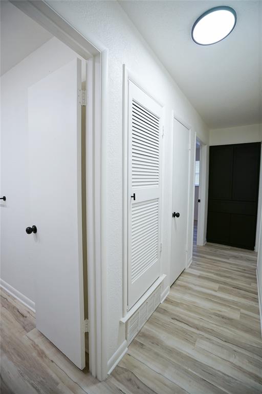 2409 Southwest Sunset Lane Burleson, TX 76028 - Photo 12 of 18 Corridor with light wood-type flooring
