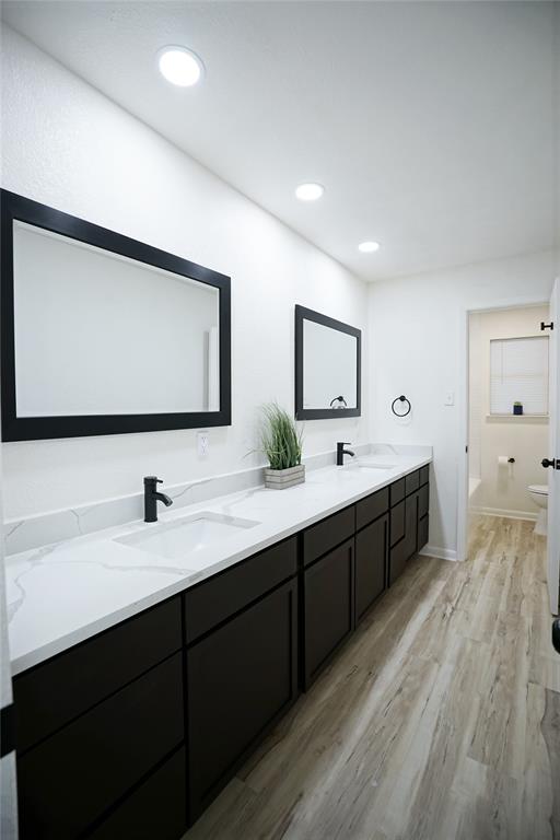2409 Southwest Sunset Lane Burleson, TX 76028 - Photo 13 of 18 Bathroom with hardwood / wood-style floors, toilet, and vanity