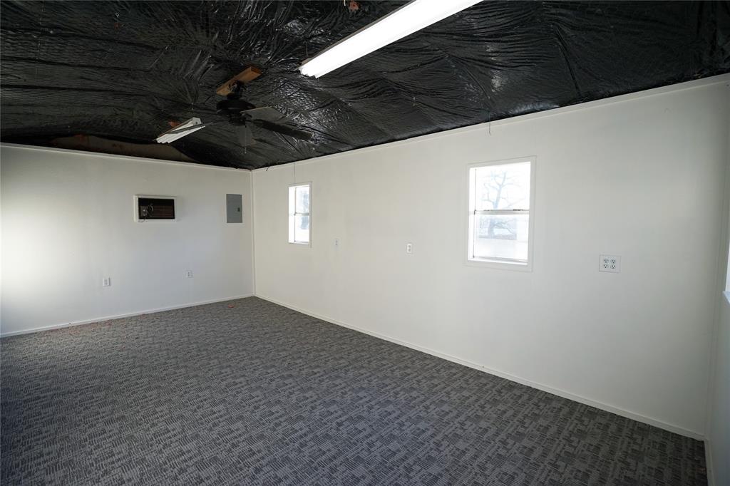 2409 Southwest Sunset Lane Burleson, TX 76028 - Photo 18 of 18 Carpeted empty room with electric panel and ceiling fan