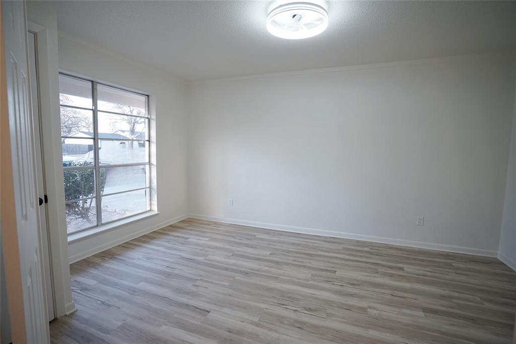 2409 Southwest Sunset Lane Burleson, TX 76028 - Photo 6 of 18 Unfurnished room with a wealth of natural light, ornamental molding, and light wood-type flooring