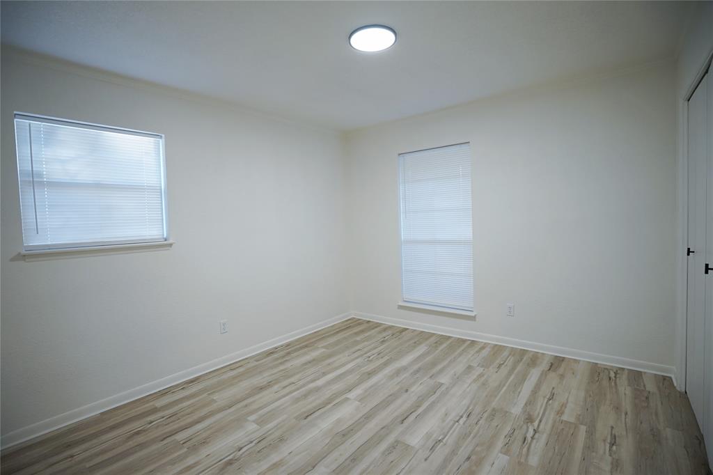 2409 Southwest Sunset Lane Burleson, TX 76028 - Photo 10 of 18 Empty room featuring light hardwood / wood-style flooring